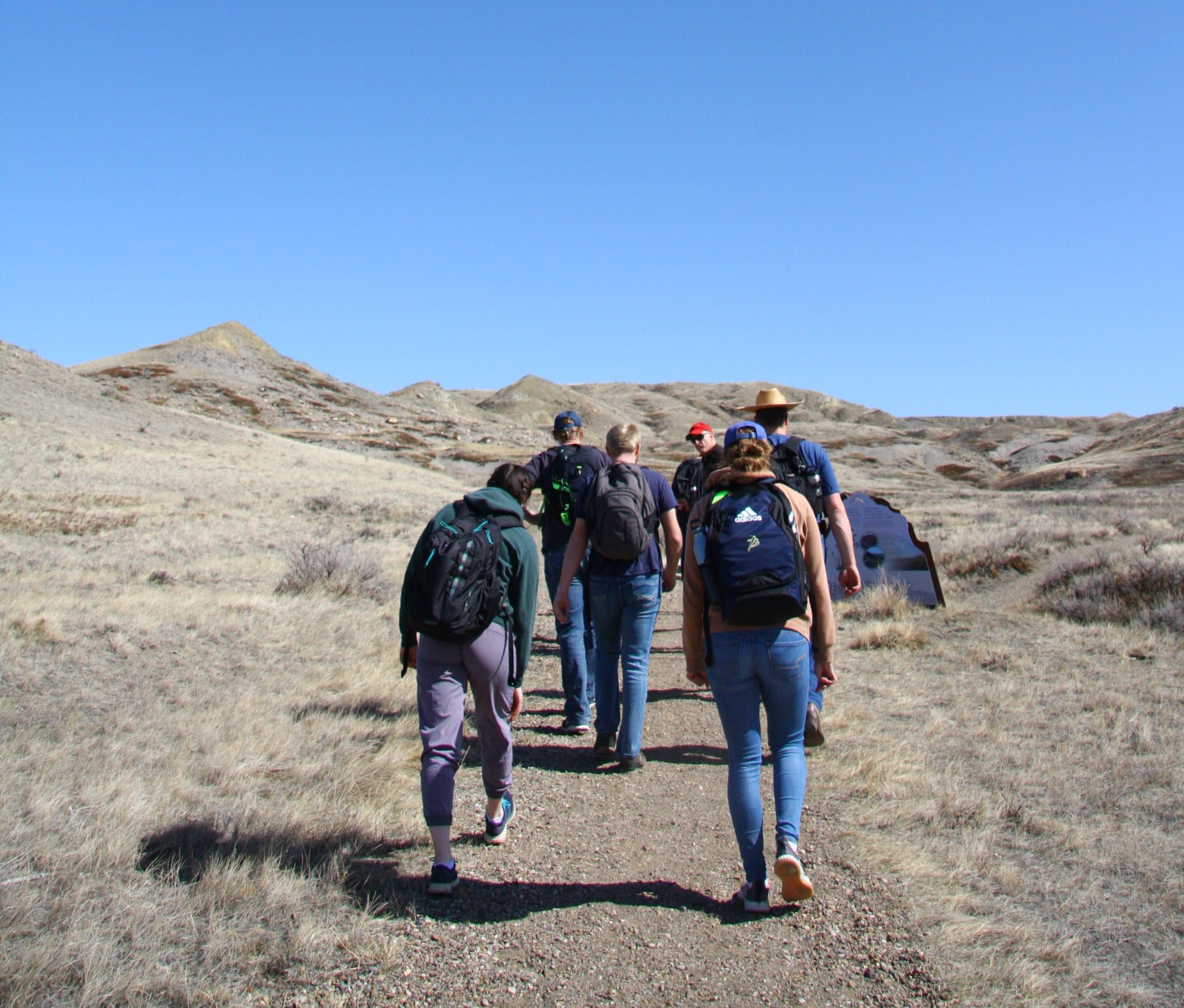 Members of Via Caronport walking together through the Saskatchewan prairie